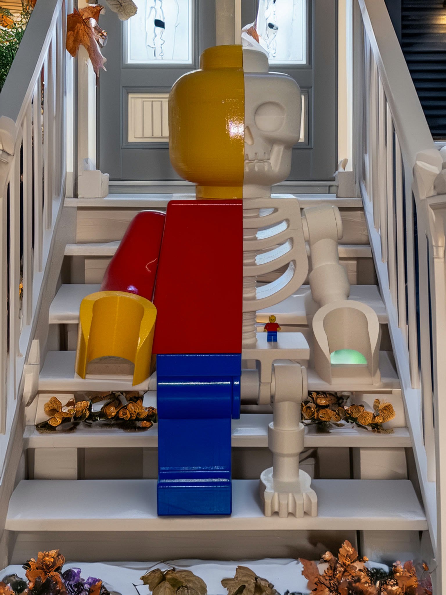 The 24-inch Skeleton Fig standing on white porch steps scattered with autumn leaves, a standard minifigure on its hip